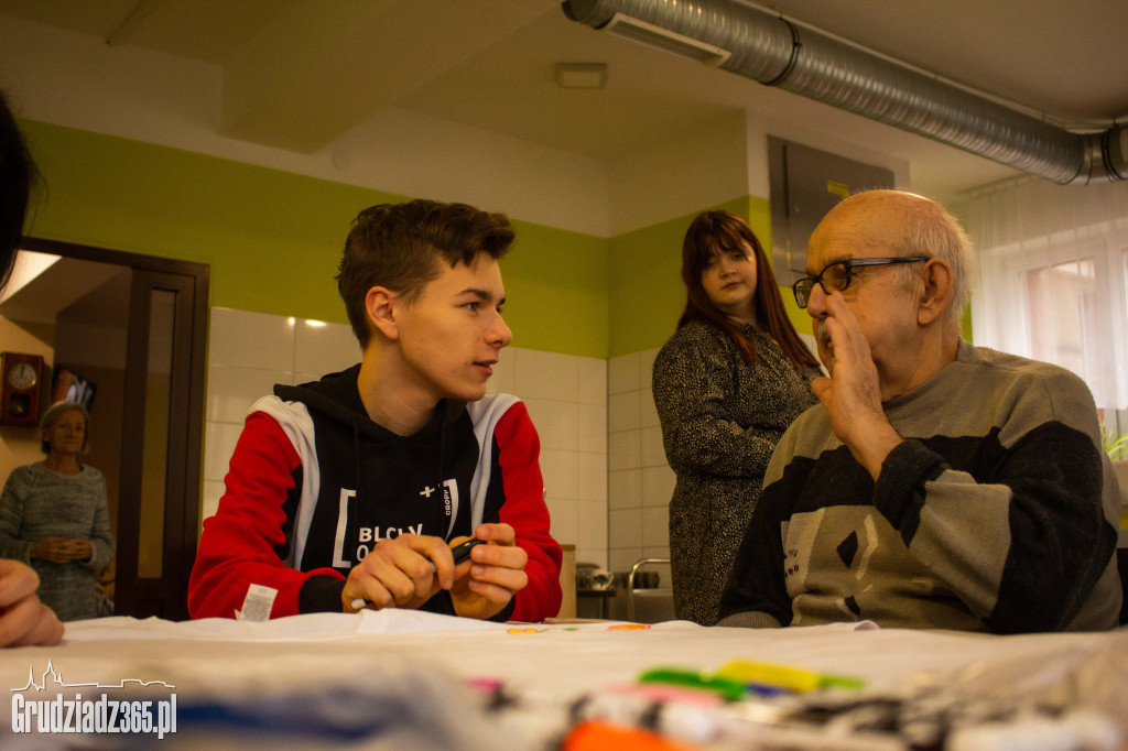 Grupa młodych osób realizuje projekt - Integracja międzypokoleniowa